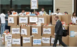  ?? — AP ?? Anti- Brexit activists protest as they deliver a pile of medical supplies in cardboard boxes to the department of health and social care in London. Our Future, Our Choice ( OFOC) Pro- EU campaign group wants get its message to the public surroundin­g the predicted costs of Britain’s ‘ No Deal Hard Brexit’, exit from the EU.