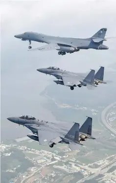  ??  ?? A US Air Force B-1B Lancer (top) flying with South Korean F-15K fighter jets over US Osan Air Base in Pyeongtaek. — AFP photo