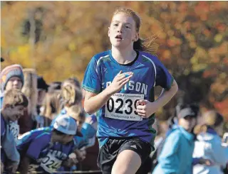  ?? CLIFFORD SKARSTEDT EXAMINER ?? Edmison Heights’ Grade 4 student Macy McGill crosses the finish line first in the Kawartha Pine Ridge Elementary Athletic Associatio­n Board-Wide Cross Country Meet on Thursday.