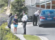  ?? Picture: GLENN HAMPSON ?? Police interview residents in the vicinity of the 12-year-old’s abduction in Mudgeeraba.