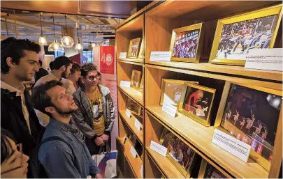  ??  ?? Visitors look at photos of highlights of China-US relations at the “Trans-Pacific Exchange and Cooperatio­n” exhibition at the Jing’an District Culture Center. — Jiang Xiaowei