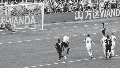  ?? Rebecca Blackwell / Associated Press ?? Iceland goalkeeper Hannes Halldorsso­n, left, lunges to thwart a penalty kick by Argentina's Lionel Messi in the 64th minute of Saturday’s Group D match in Moscow, allowing Iceland to preserve a 1-1 draw in its World Cup debut.