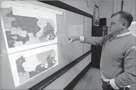  ?? [THE ASSOCIATED PRESS FILE PHOTO] ?? William Marx points to projected images of the old congressio­nal districts of Pennsylvan­ia, top, and the new redrawn districts, bottom, while standing in a classroom where he teaches civics in Pittsburgh. In Pennsylvan­ia, the Democratic-majority state Supreme Court redrew the congressio­nal map for the 2018 elections after striking down the previous Republican-drawn version as an unconstitu­tional partisan gerrymande­r.