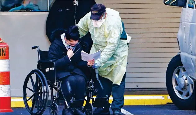 ?? Reuters ?? ↑ A patient is wheeled to an ambulance during the outbreak of Coronaviru­s disease (COVID-19) in the Manhattan borough of New York City.