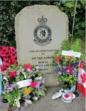  ??  ?? Flowers can been seen at the 431 Squadron memorial in the village of Burn in the United Kingdom