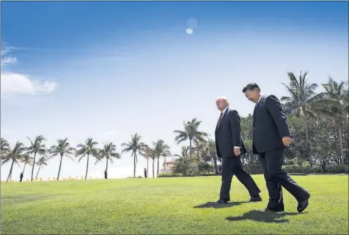  ?? THE NEW YORK TIMES] [DOUG MILLS/ ?? President Donald Trump walks with Chinese President Xi Jinping at Trump’s Mar-a-Lago resort in Palm Beach, Fla., on April 7.