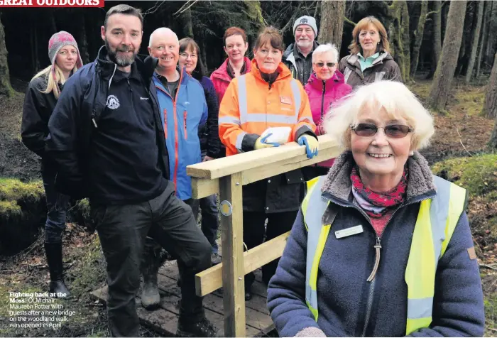  ??  ?? Fighting back at the Moss FOLM chair Maureen Potter with guests after a new bridge on the woodland walk was opened in April