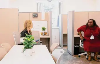  ?? ?? The Harris Center for Mental Health and IDD staff work in their office at the navigation center, which helps homeless people whose encampment has been targeted for decommissi­oning.