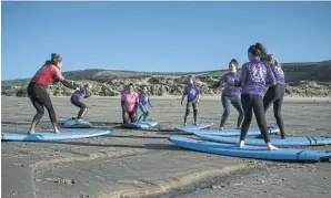  ?? ?? FAR LEFT
The instructor Yvette Curtis guides young members of the Wave Wahines, a women- and girls-only surf club.