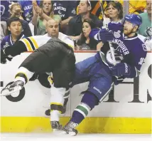  ?? ELSA/GETTY IMAGES ?? Jannik Hansen of the Vancouver Canucks tussles with Boston's Shawn Thornton during Game 7 in Vancouver in 2011.