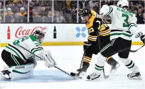  ?? (USA TODAY Sports) ?? Dallas Stars goaltender Anton Khudobin (left) blocks a shot by Boston Bruins’ Brad Marchand (centre) during the NHL game in Boston, Massachuse­tts, on Monday.