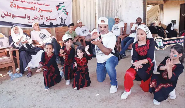  ?? Agence France-presse ?? ↑
Palestinia­ns perform a traditiona­l dabke dance during a cultural event at the Maghazi camp in Gaza on Thursday.