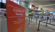  ?? STuART cAHILL / BosTon HeRALd ?? TESTING STILL KEY: COVID-19 signs in Terminal C of Logan Internatio­nal Airport tell people where testing is available on Feb. 10.
