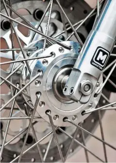  ??  ?? Left: Front hub is offset even on a stock Commando. The hub on this bike has to stay offset due to the wide caliper, but the rigidity is improved over standard by a better spoking pattern