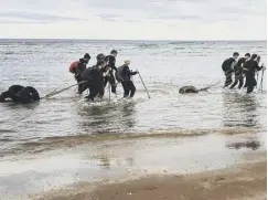  ?? PICTURES: Chris Marks ?? The Bathgate pupils hauling their sleds across the ice in Greenland, main; cameraman Jack Warrender filming the teenagers, top left; training on a beach in St Andrews, above