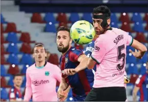  ?? AFP ?? Levante’s Spanish midfielder Jorge Miramon (centre) vies with Barcelona’s Spanish midfielder Sergio Busquets during the Spanish league football match on May 11.