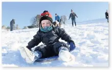  ??  ?? > Toddler Rowan O’Keefe enjoys the snow at Storey Arms