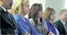  ?? ALEX WONG/GETTY IMAGES ?? Sabine Durden, centre, of Mineral Spring, Arkansas holds hands with other victims’ family members during a news conference.