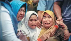  ?? HADI SUTRISNO / AFP ?? Family members of the crashed plane react at Pangkal Pinang airport in Bangka Belitung province.