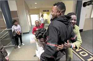  ?? NWA Democrat-Gazette/J.T. WAMPLER ?? John Feruzi receives hugs from aunt Nyasa Safi and cousin Josephina Richard on Tuesday after arriving at the Northwest Arkansas Regional Airport in Highfill.