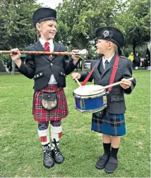  ??  ?? Evie Braiden, 7, and her brother Joshua, 5, from Romford, join members of 214 bands at the 72nd World Pipe Band Championsh­ip on Glasgow Green yesterday.