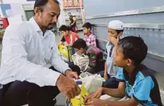  ??  ?? ZAINUDIN melihat barangan keperluan yang dibeli.