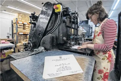  ?? PHOTO: REUTERS ?? The royal treatment . . . Lottie Small use the die stamping press at the London workshop of Barnard and Westwood, which is printing the invitation­s for Britain’s Prince Harry and Meghan Markle’s wedding at Windsor Castle in May.