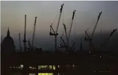  ?? Reuters ?? Constructi­on cranes rise above the London skyline. There are concerns that London property prices are overvalued.