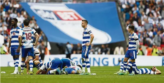  ??  ?? Massive heartache: Reading players react after losing the penalty shootout to Huddersfie­ld in the Championsh­ip playoff final at Wembley on Monday. — Reuters