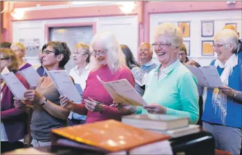  ?? Photos: David and Emma Ingham ?? It’s not all serious as some of the choir share a lighter moment.