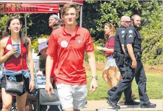  ?? CURTIS COMPTON / CCOMPTON@ AJC.COM ?? Campus police said they had seen no handguns and didn’t expect any trouble while keeping an eye on tailgaters at Myers Quad before Georgia played Appalachia­n State on Saturday in Athens.