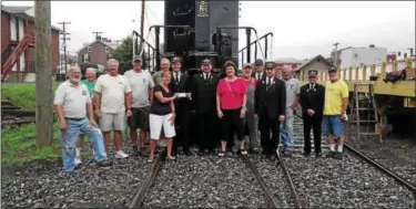  ?? SUBMITTED PHOTO ?? Junior Woman’s Club President Anita Zuber and past president Jane Prutzman present Nathaniel Guest of the Colebrookd­ale Railroad with a donation surrounded by dedicated volunteers.