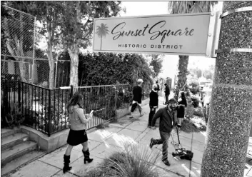  ?? AP Photo/Chris Pizzello ?? In this Feb. 25 file photo, members of the media and neighbors walk near an area on North Sierra Bonita Ave. where Lady Gaga’s dog walker was shot and two of her French bulldogs stolen in Los Angeles.