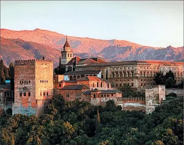  ?? DOMINIC ARIZONA BONUCCELLI/RICK STEVES’ EUROPE ?? The Moorish quarter in Granada, Spain, offers a fine vantage point as the setting sun turns the Alhambra fortress red.