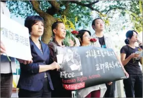  ??  ?? Human rights activists display a banner of jailed Taiwanese NGO worker Lee Mingcheh during a protest in Taipei yesterday.