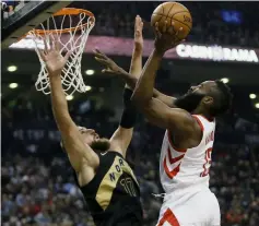  ??  ?? James Harden (right) shoots against against Toronto Raptors center Jonas Valanciuna­s during the first half at the Air Canada Centre in this March 9 file photo. — USA TODAY Sports