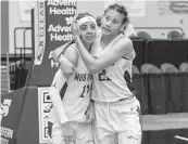  ?? D.A. VARELA dvarela@miamiheral­d.com ?? Horeb Christian’s Emely Rodriguez, right, consoles teammate Aliana Davila after losing to Faith Christian.