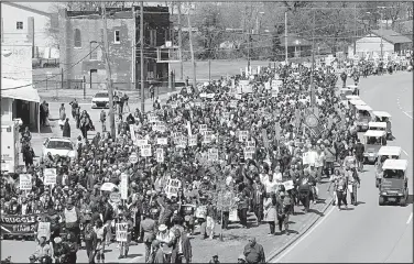  ?? AP/MARK HUMPHREY ?? A line of marchers winds through Memphis on Wednesday to commemorat­e the 50th anniversar­y of the assassinat­ion of the Rev. Martin Luther King Jr.