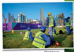  ?? GETTY IMAGES ?? Ghost town: workers on the Corniche promenade in Doha