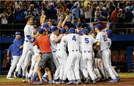  ?? AP ?? Florida players celebrate at home plate after Austin Langworthy’s walk-off home run against Auburn in the bottom of the 11th of an NCAA super regional Monday.