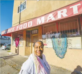 ?? ARLEN REDEKOP ?? Mount Pleasant artist Deirdre Pinnock has received funding from the Neighbourh­ood Grants Committee to add crocheted hearts to abandoned storefront­s. She calls the project It's Nobody's Business.