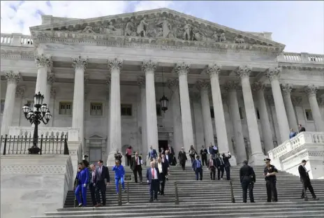  ?? Susan Walsh/Associated Press ?? Members of the House of Representa­tives walk down the steps on Capitol Hill on Friday after passing a coronaviru­s rescue package in Washington.