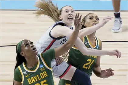  ?? AP photo ?? UConn’s Paige Bueckers (center) drives to the basket between Baylor’s Queen Egbo (left) and DiJonai Carrington during the Huskies’ Elite Eight win in the women’s NCAA Tournament on Monday.