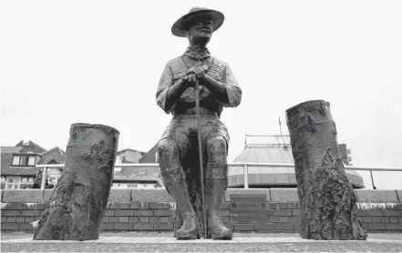  ?? MATTHEW CHILDS REUTERS ■ ?? A statue of Robert Baden-Powell is seen in Poole, England. The statue is being given 24-hour security until it is removed or until the threat subsides following protests against the death of George Floyd who died in police custody in Minneapoli­s.