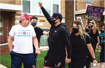  ?? ASHLEE REZIN GARCIA/SUN-TIMES ?? A man wearing a “Keep America Great” hat argues with Black Lives Matter protesters as they march through the Garfield Ridge neighborho­od on the Southwest Side last week.