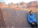  ??  ?? These days, Jeff Gilkey usually discovers evidence of past civilizati­ons while flying his ultralight. In this 2009 photograph, however, he gets up close and personal with petroglyph­s at Mexican Mountain, Utah, near Moab.