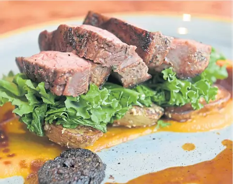  ??  ?? Garlic and rosemary rump of Highland lamb served with black pudding, curly kale, skirlie potatoes and carrot puree.