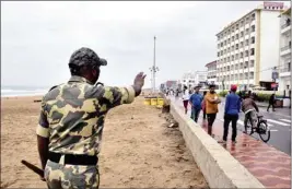  ?? PTI ?? A cop stops tourists from visiting a sea shore in the wake of Cyclone Jawad, in Puri, on Saturday