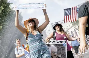  ?? John Minchillo/Associated Press ?? Supporters of Bernie Sanders for president march during a demonstrat­ion Sunday in downtown Philadelph­ia.