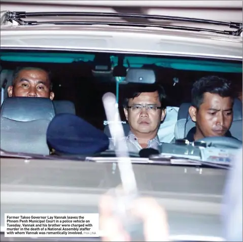  ?? PHA LINA ?? Former Takeo Governor Lay Vannak leaves the Phnom Penh Municipal Court in a police vehicle on Tuesday. Vannak and his brother were charged with murder in the death of a National Assembly staffer with whom Vannak was romantical­ly involved.